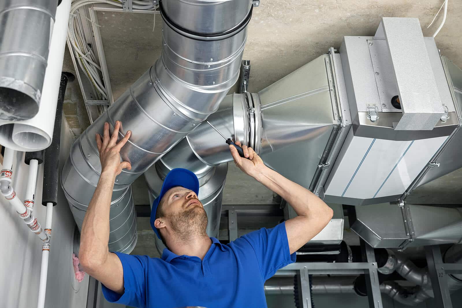 HVAC technician inspecting and repairing air ducts in Laguna Niguel